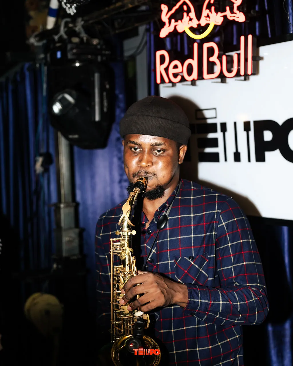 A saxophonist playing under the Red Bull and TEMPO sign